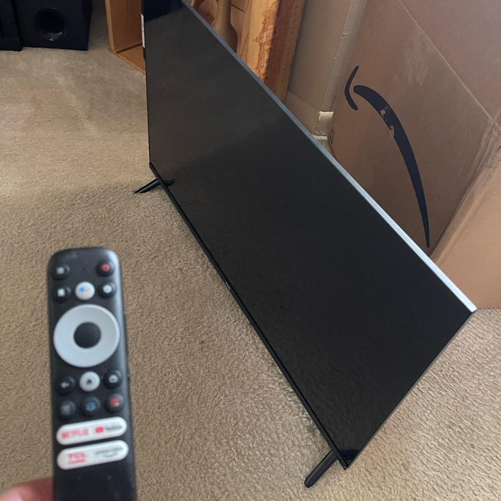 Sleek Black Flat Screen TV with Remote